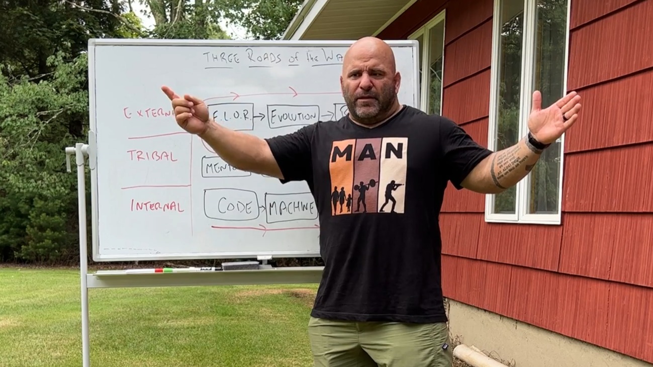 Master Chim teaching at a whiteboard outside, arms spread wide
